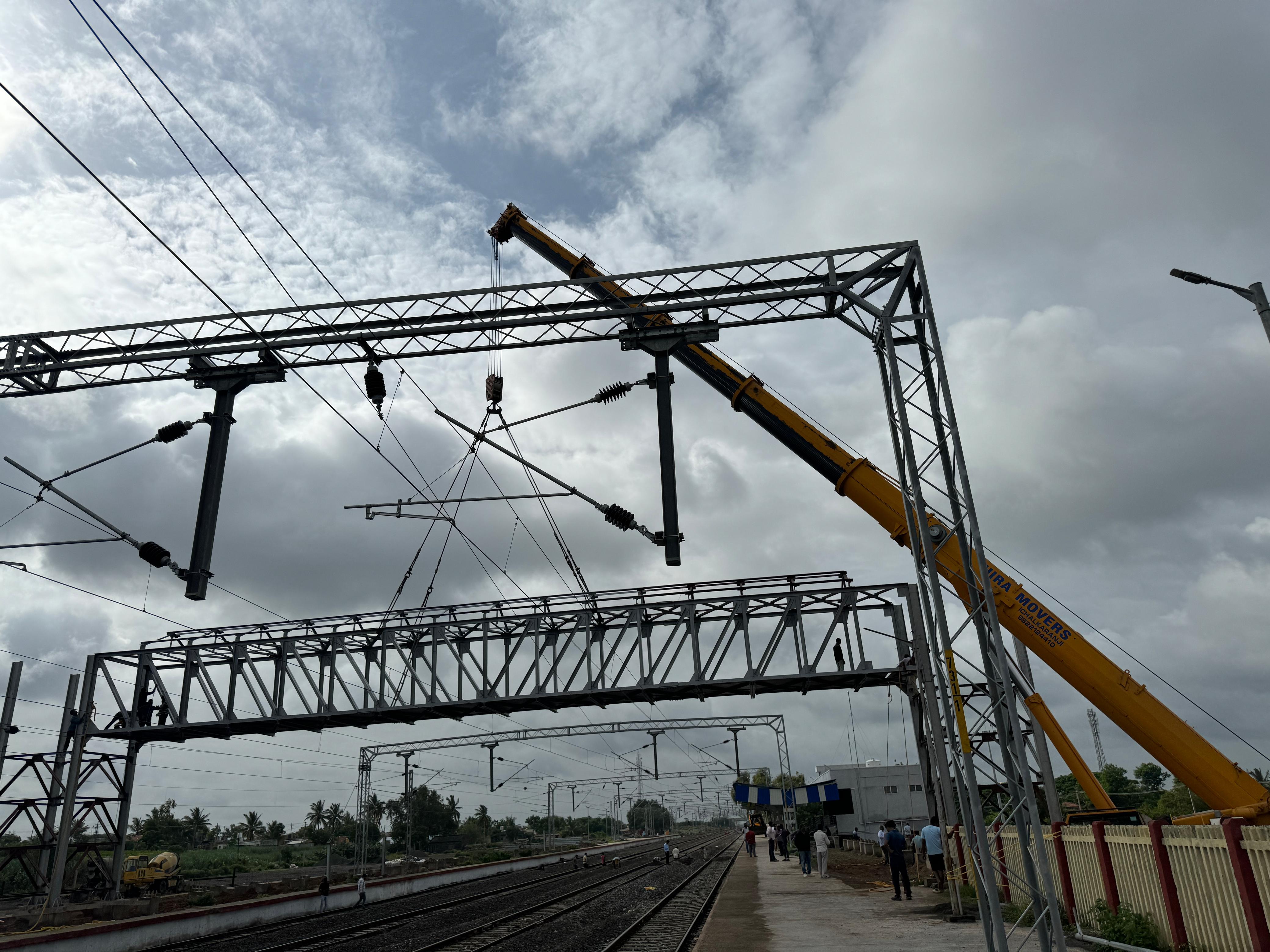 Crane installing railway overhead structure